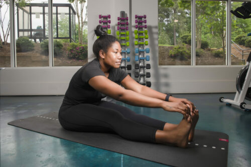 Girl stretching in fitness center during workout at Evolve