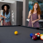 let the evolution begin girls playing pool at evolve community