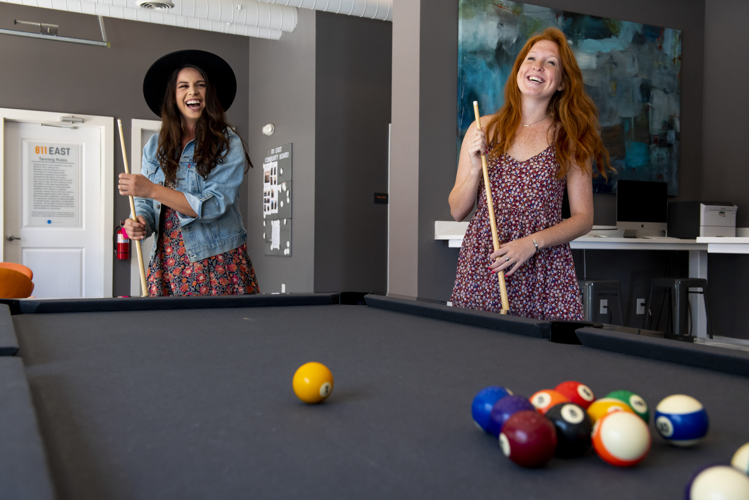 let the evolution begin girls playing pool at evolve community