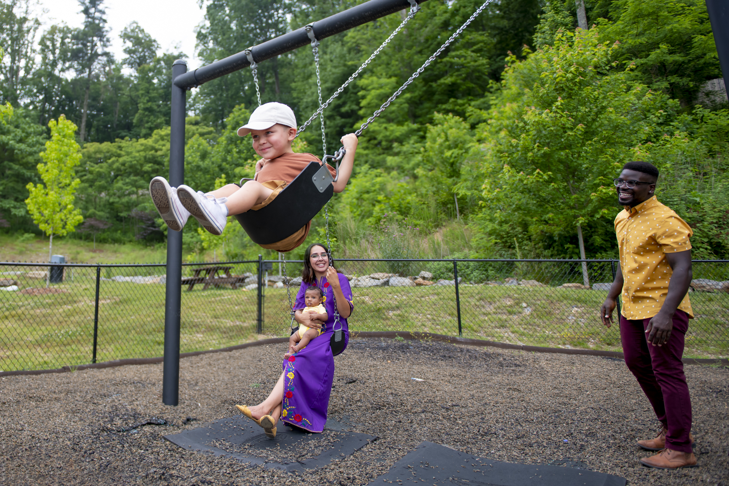kids on swingset at evolve community playground