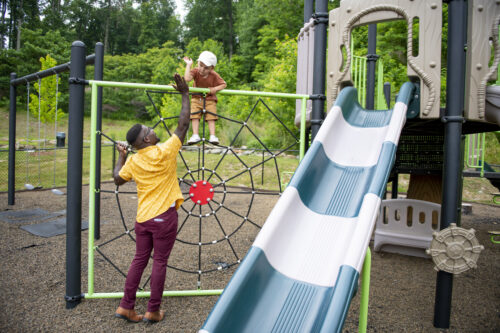 family on playground at evolve community