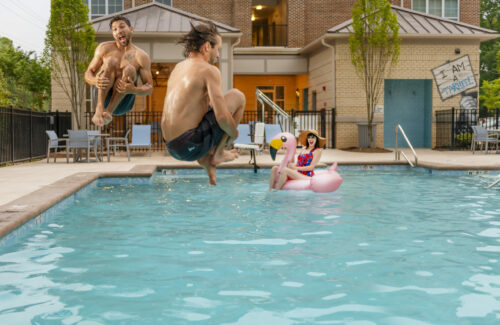 people playing in pool at evolve community