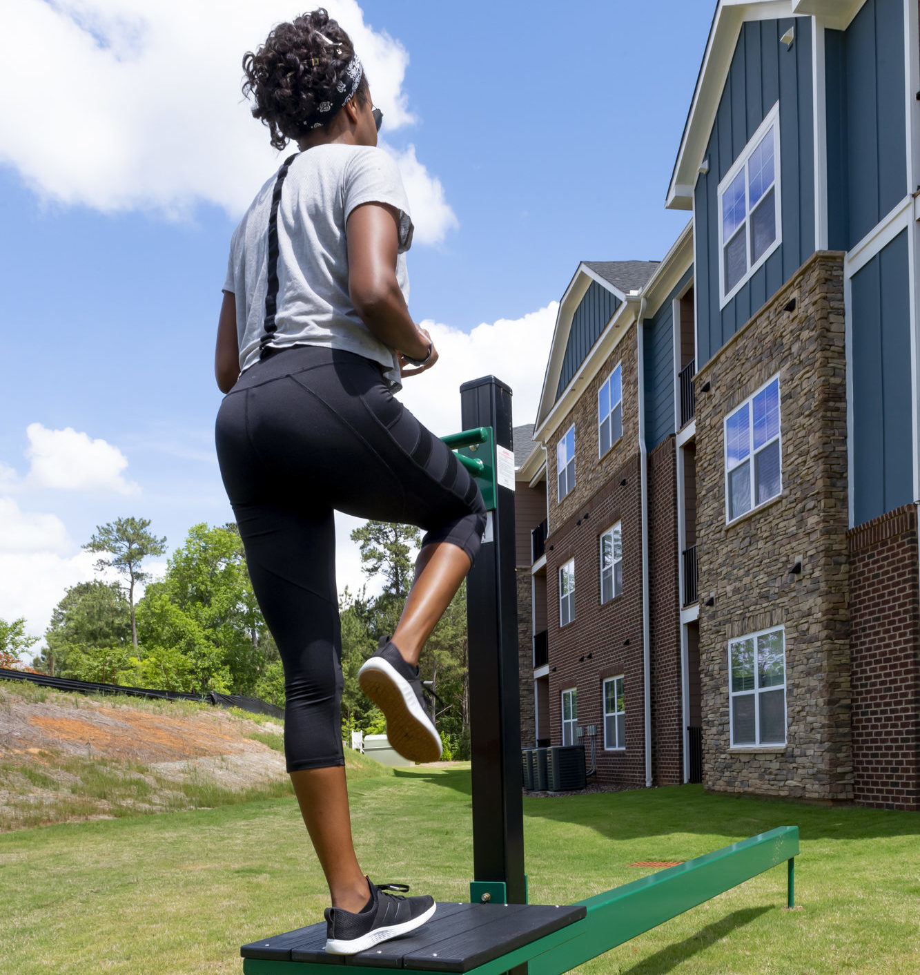 girl on outdoor fitness equipment at evolve community