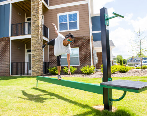 girl on outdoor fitness equipment at evolve community