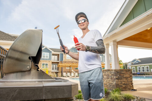 guy grilling hotdogs at evolve summer recipes