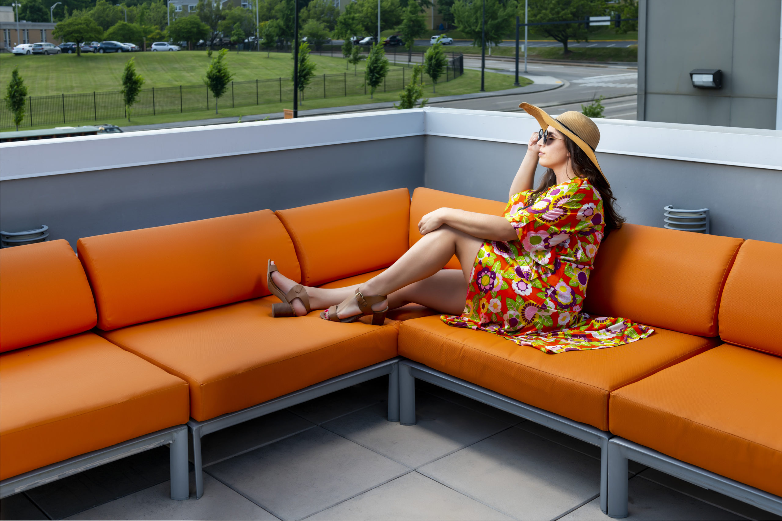 girl on orange couch outdoors at evolve community