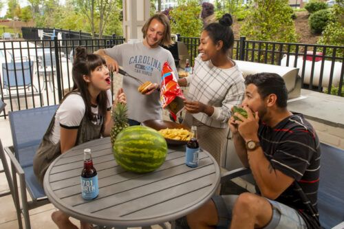 people grilling eating chips and dip at evolve summer recipes