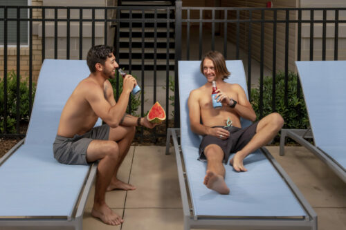 guys with watermelon on pool deck summer recipes evolve