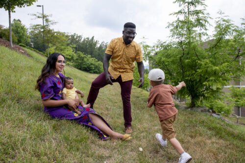 family playing on hill outdoors road trip spots