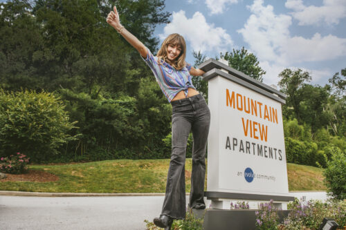 girl standing by sign at mountain view road trip spots