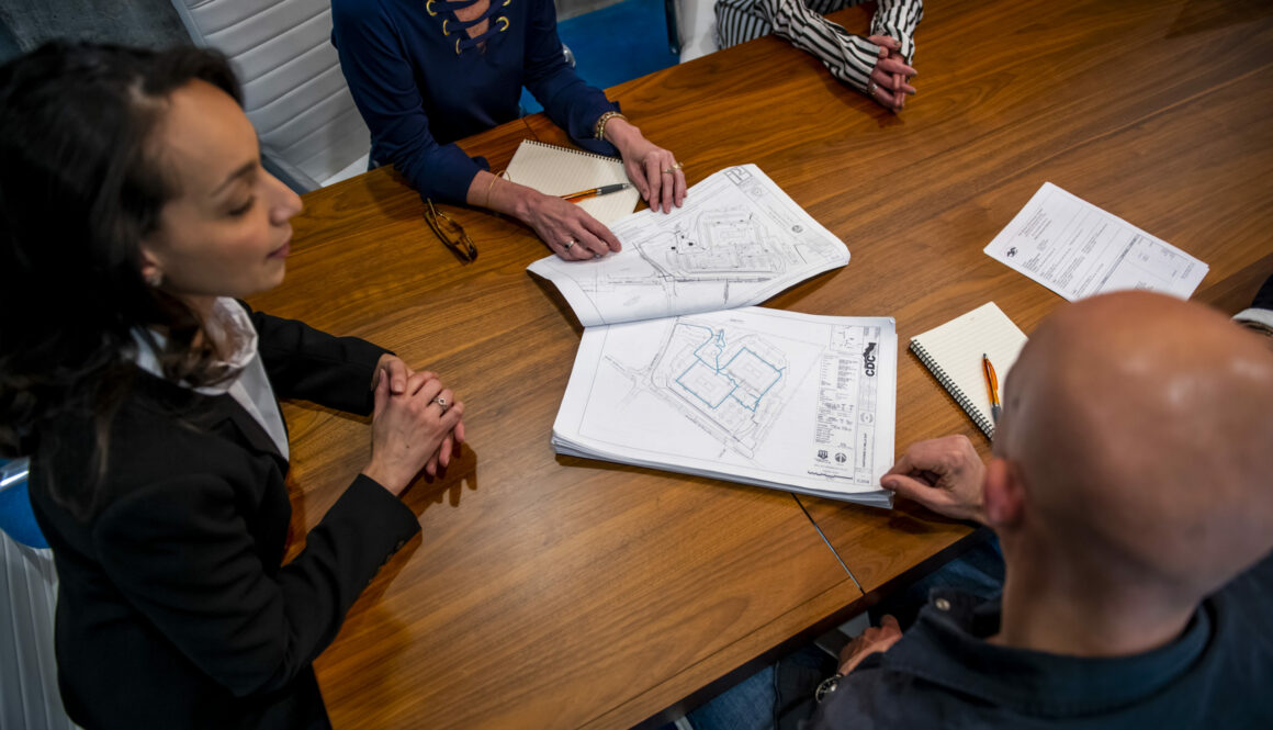 conference table with construction blueprints