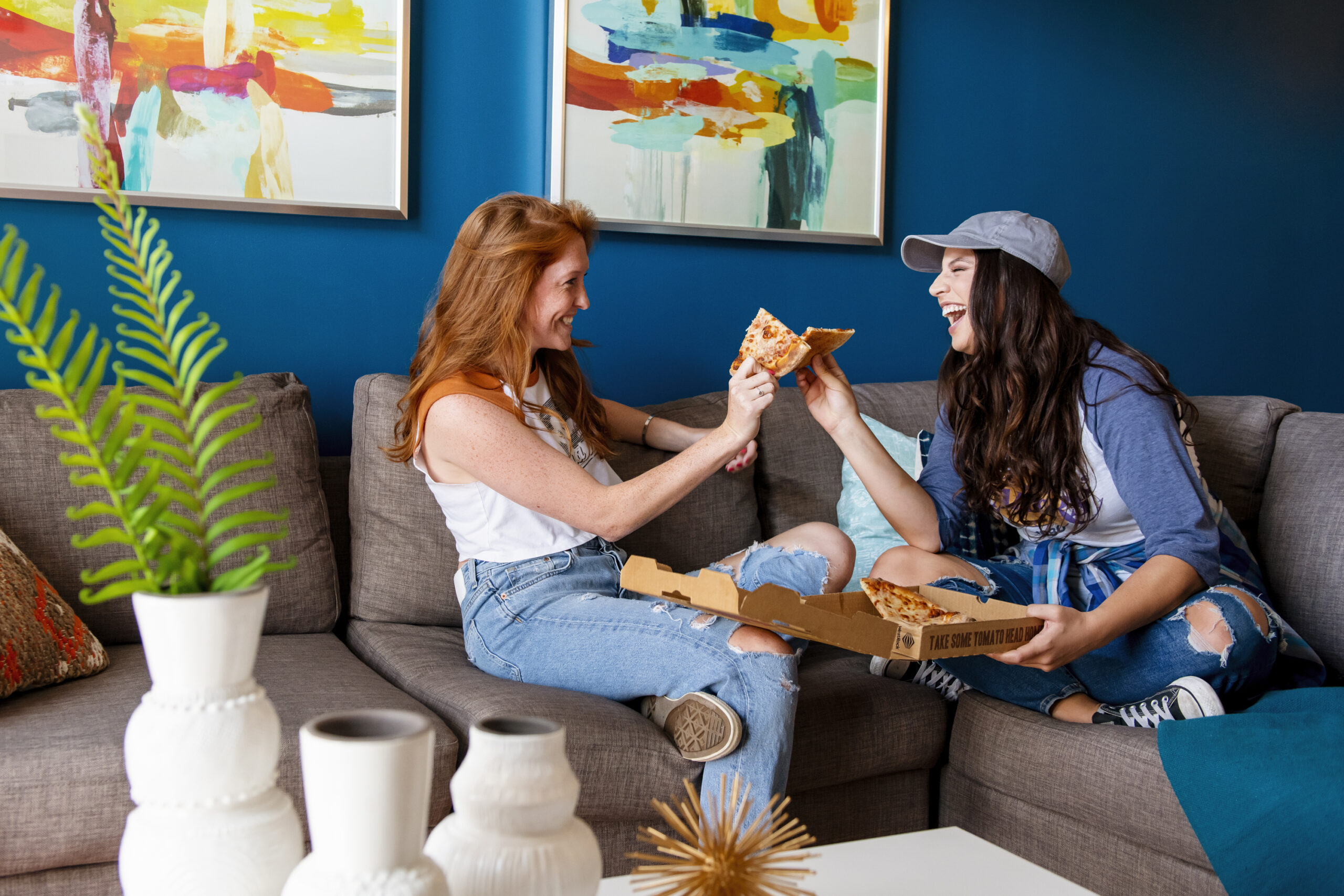 girls eating pizza on couch evolve blog