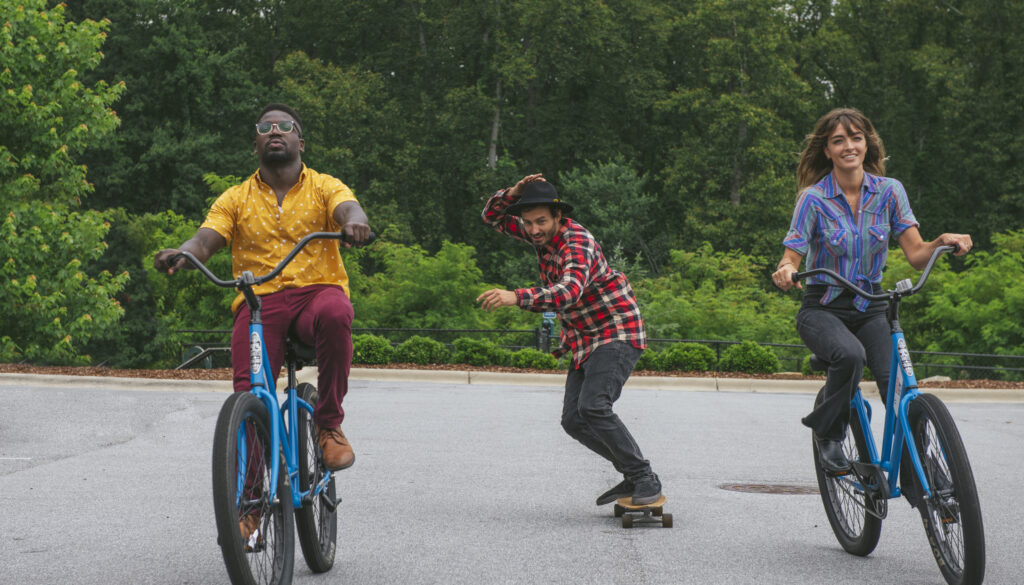 people riding bikes and skateboarding outdoors at evolve