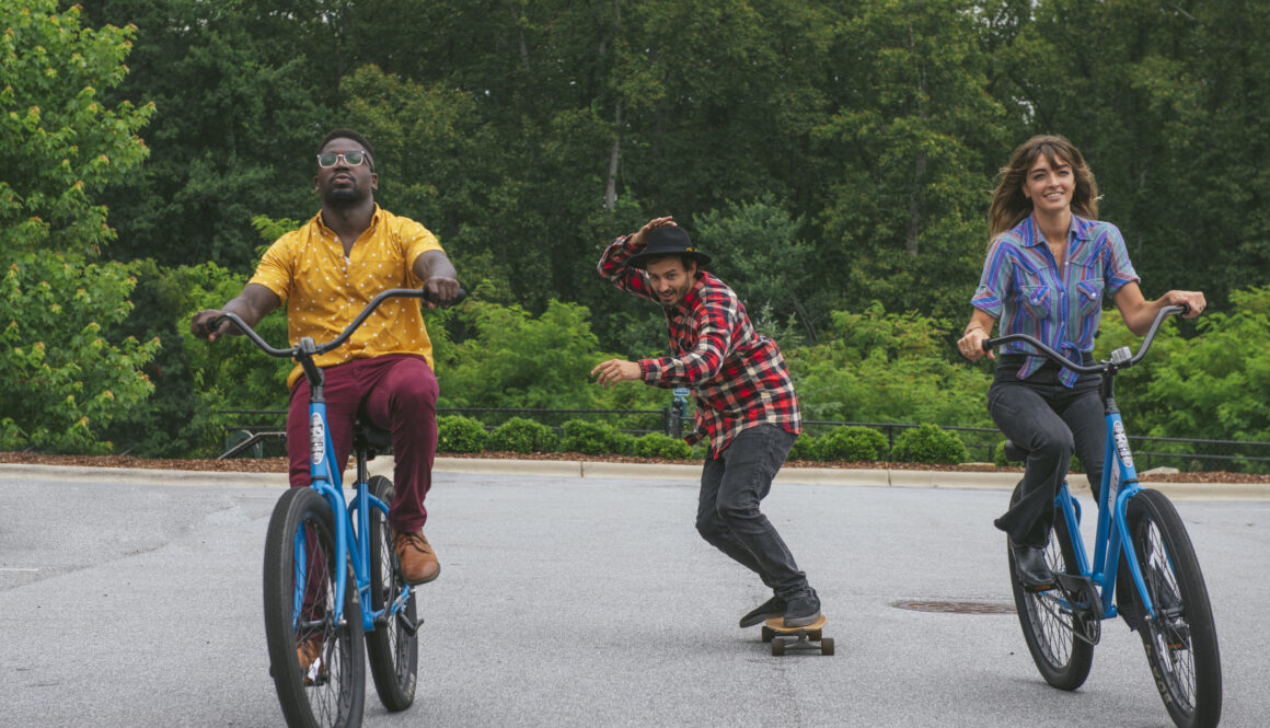 people riding bikes and skateboarding outdoors at evolve