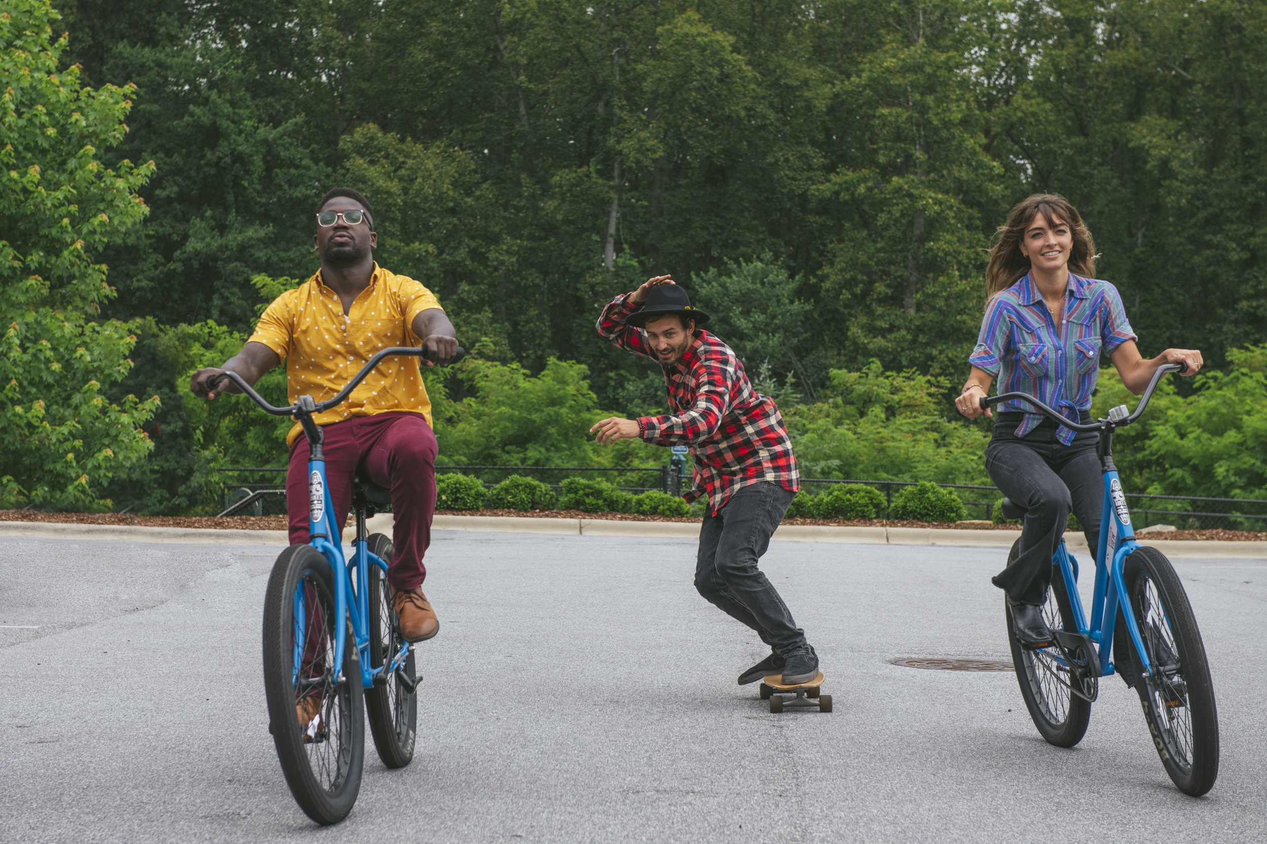 people riding bikes and skateboarding outdoors at evolve
