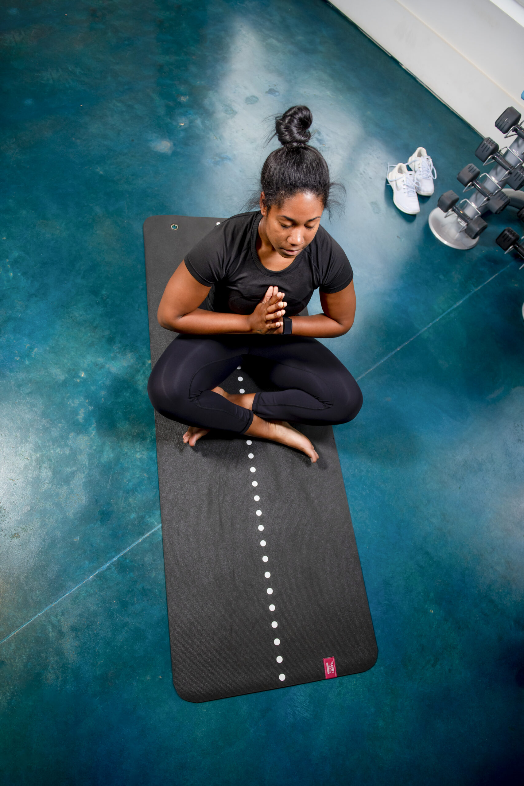 girl meditating in yoga room evolve blog amenities