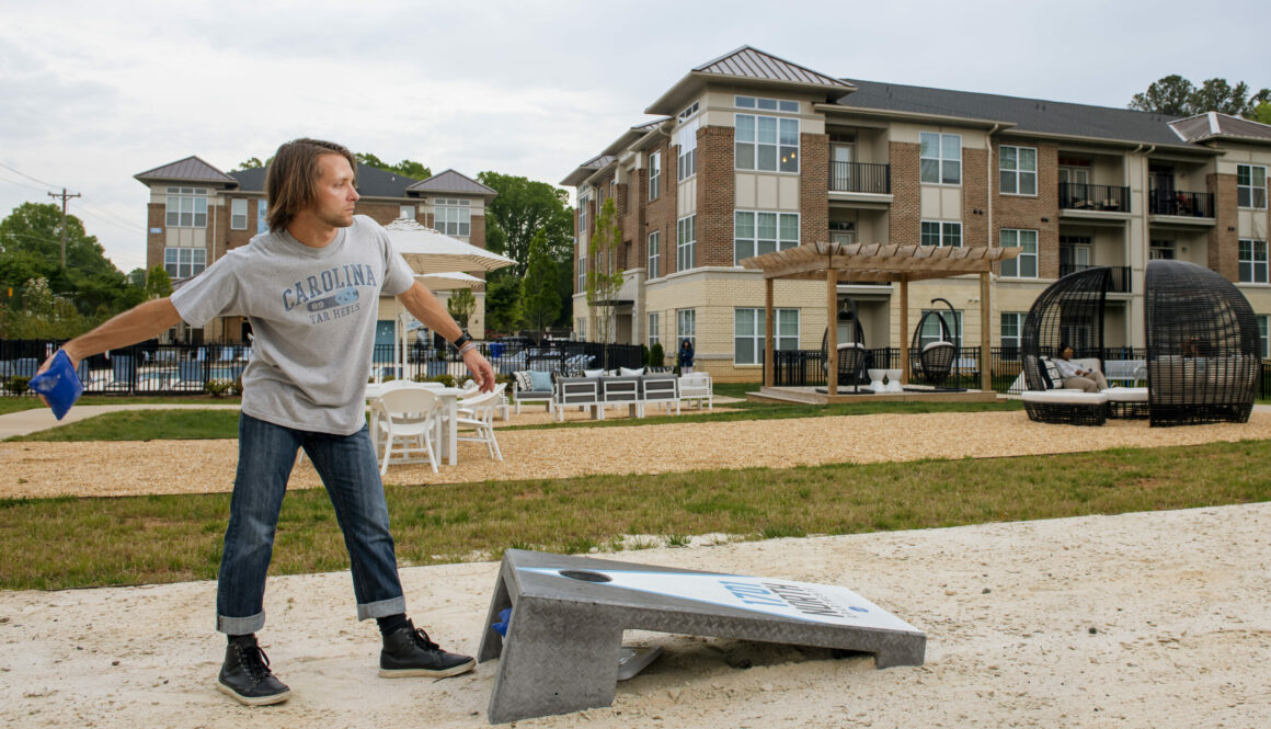 evolve blog summer outdoors guy playing cornhole