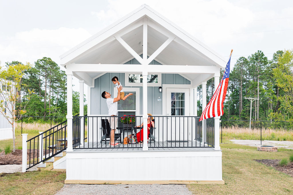 evolve-blog-oceans-rv-resort-premium-cabin family on front porch of cabin at rv resort