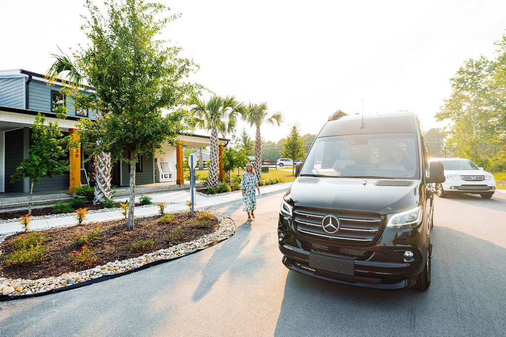 van pulling up to oceans rv resort clubhouse and amenities