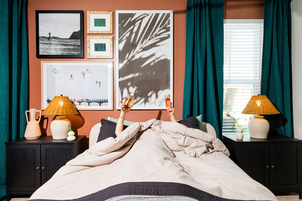 evolve-waterford-bedroom-art person laying in bed with drinks in their hands at Evolve Waterford