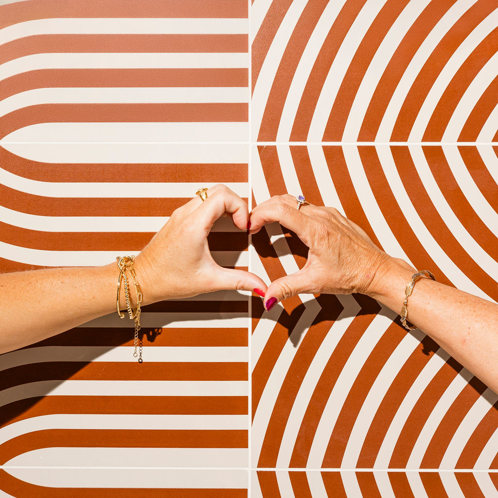 two people holding their hands up in the shape of a heart at Evolve Waterford