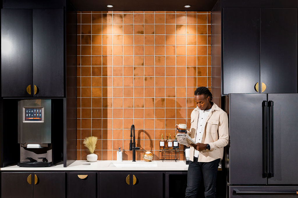 evolve-waterford-kitchen-coffee man reading newspaper in resident kitchen at Evolve Waterford