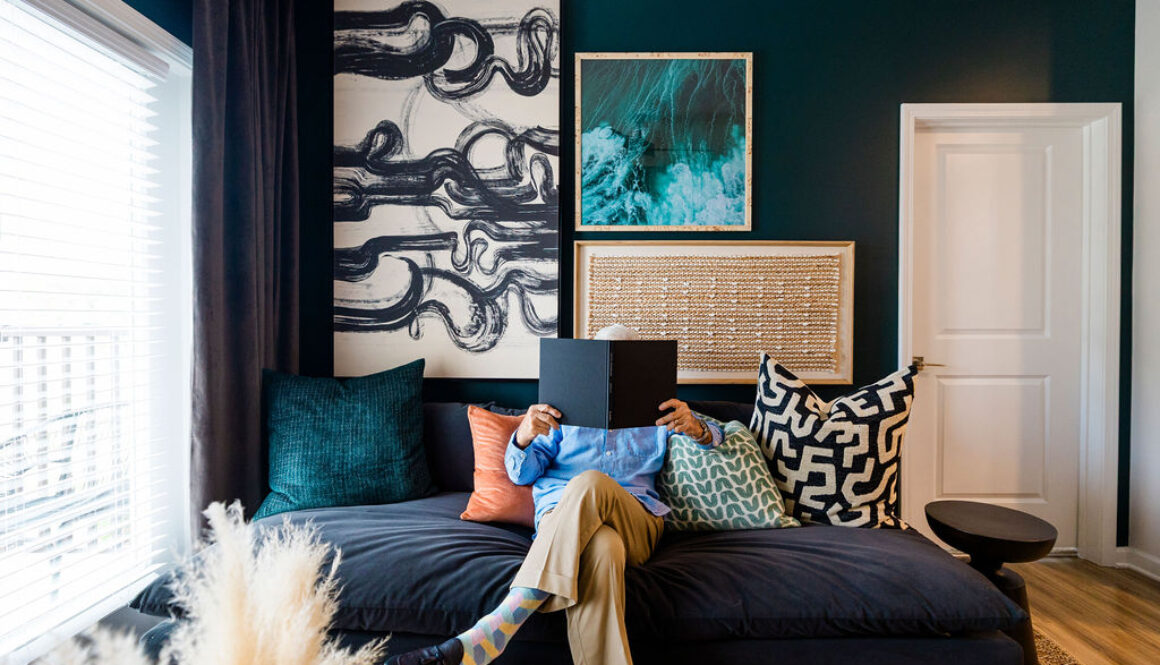 man reading book on couch at Evolve Waterford