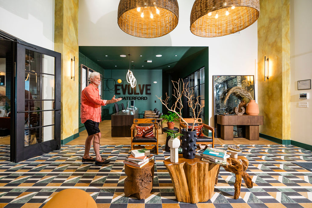 man throwing tennis ball in leasing office at Evolve Waterford